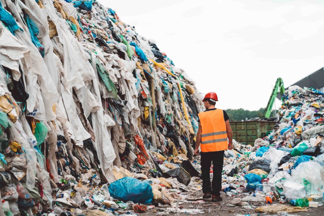 Homme marchant au milieu de détritus issus de l'industrie du textile